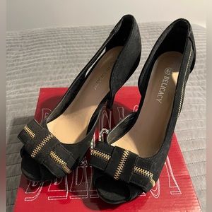 Size  6.5 black heels with a zipper accent.